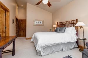 a bedroom with a large bed and a wooden table at Abode at Sweetwater in Wilson