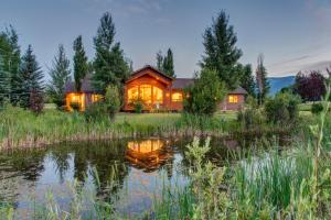 a home with a pond in front of it at Abode at Sweetwater in Wilson