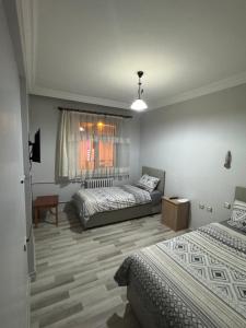 a bedroom with two beds and a window at Mk Bigg Boss Otel in Erzurum