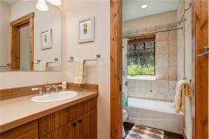 a bathroom with a sink and a toilet and a tub at Abode at Skyline in Jackson +31 photos