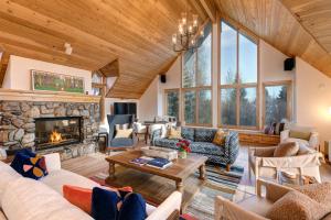 a living room with couches and a fireplace at Abode at Golden Spruce in Wilson