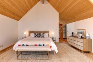 a bedroom with a bed and a wooden ceiling at Abode at Golden Spruce in Wilson
