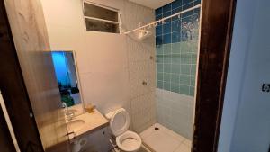 a bathroom with a toilet and a sink and a shower at Mirante Rota do Mar in Maceió +31 photos