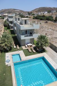 an aerial view of a house with a swimming pool at Holiday Luxury Villas in Kalamaki