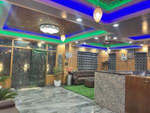 a lobby of a hotel with a bar and couch at Hotel Shuhrah-I-Afaq - Near Srinagar Airport in Baghwānpur