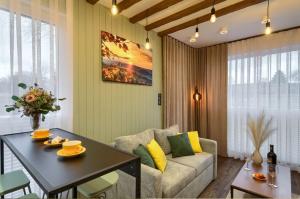 a living room with a table and a couch at Cicho Sza in Tylicz