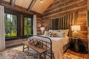 a bedroom with a bed and a wooden wall at Abode at Teton Game in Wilson