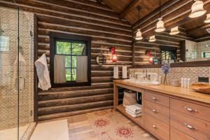 a bathroom with a sink and a shower with wooden walls at Abode at Teton Game in Wilson +68 photos