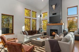 a living room filled with furniture and a fireplace at Abode at Alpenglow in Wilson