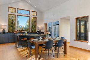 a kitchen and dining room with a table and chairs at Abode at Alpenglow in Wilson