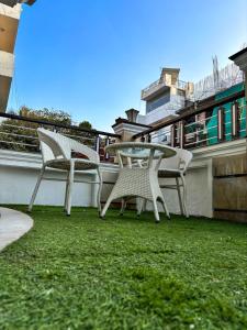 two chairs and a table on a balcony at Sparra Homes in Gurgaon