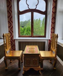 a table and two chairs in front of a window at Kasteel Rosmeulen in Mall +8 photos