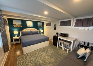 a bedroom with a bed and a table and a couch at The Edenwild Boutique Inn in Lopez