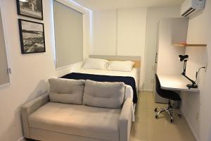 a living room with a couch and a bed at Nobile Stays Ininga in Teresina