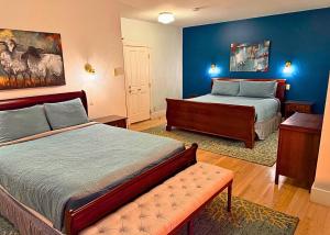 a bedroom with two beds with blue walls at The Edenwild Boutique Inn in Lopez