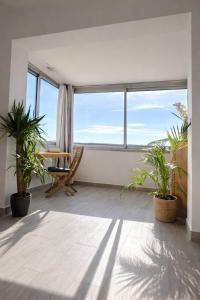 a living room with a table and potted plants at Etrave in Toulon +1 photo