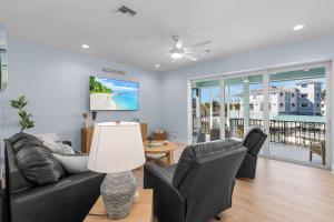 a living room with a couch and chairs at Beach Nuts by Sun Palace Vacations in Fort Myers Beach