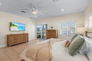 a bedroom with a bed and a ceiling fan at Beach Nuts by Sun Palace Vacations in Fort Myers Beach +103 photos