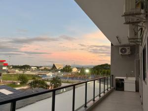 a balcony with a view of a city at sunset at Xiaos Henderson Hotel in Lungga