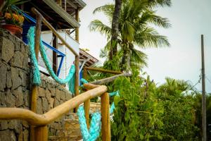 a blue rope tied to a building with a palm tree at VELINN Pousada 8 Ilhas in Ilhabela