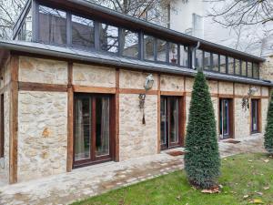 a stone house with a lot of windows at Villa Raspail in Ivry-sur-Seine