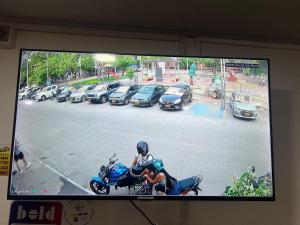 a tv screen with a person on a motorcycle on a street at HOTEL GANADERO in La Dorada +24 photos