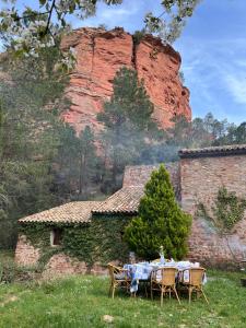 a table with chairs in front of a building at Molino Santiago in Torre de las Arcas