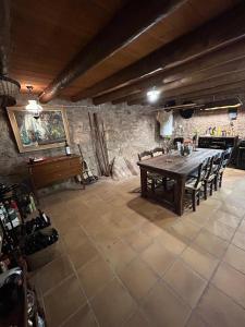 a dining room with a wooden table and chairs at Molino Santiago in Torre de las Arcas