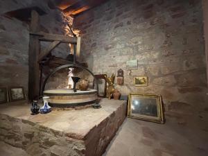 a room with a stone wall with a fireplace at Molino Santiago in Torre de las Arcas