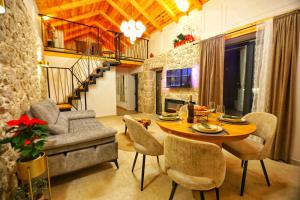 a living room with a table and a couch at Cliffside Villa Vilić in Vrgorac