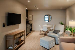 a living room with a tv and a couch and a table at Gloria Inn - Unit 8 in Waco