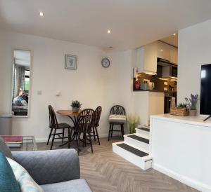 a living room with a couch and a table and chairs at The Glebe in Fort William