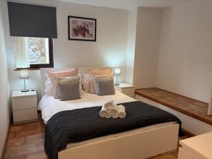 a bedroom with a large bed with a black blanket at The Glebe in Fort William