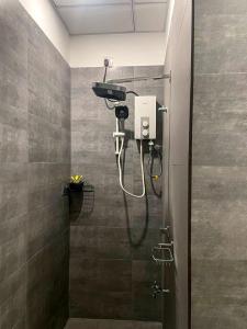 a shower in a bathroom with a shower head at Turtle Moon Lodge in Rekawa