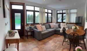 a living room with a couch and a table at The Glebe in Fort William