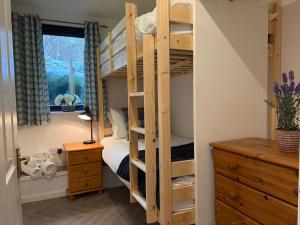 a bedroom with a bunk bed and a desk at The Glebe in Fort William +5 photos