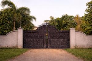 a large black gate in front of a fence at Turtle Moon Lodge in Rekawa