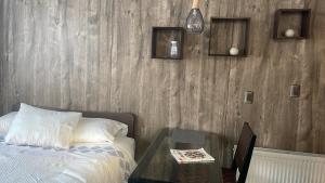 a bedroom with a bed and a glass table at Espacio Innata in Punta Arenas