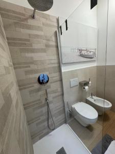 a bathroom with a toilet and a shower stall at App Borsa Trieste in Trieste