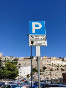 a parking lot with a parking sign in front of cars at Maisonvanilla in Cagliari