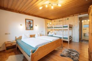 a bedroom with two beds and a bunk bed at Panek, Haus in Nesselwang