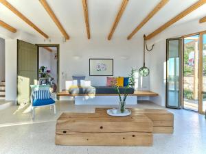 a living room with a bed and a wooden coffee table at OceanLight Horizon - luxury Villa with private pool in Nea Cryssi Akti