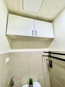 a bathroom with a toilet and a white cabinet at Marrione's Pad in Davao City