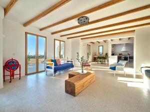 a living room with a blue couch and a table at OceanLight Horizon - luxury Villa with private pool in Nea Cryssi Akti