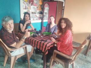 a group of people sitting around a table at Namitha guest house in Hampi +14 photos