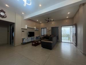 a large living room with a couch and a tv at Misty cloud homestay in Pīrmed
