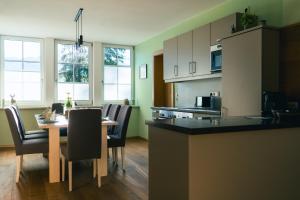 a kitchen and dining room with a table and chairs at Ferienwohnung Kahlseneck in Fischerndorf +10 photos