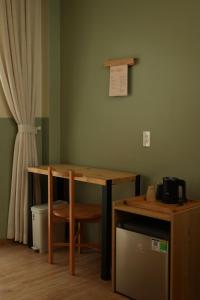 a wooden table with a chair next to a desk at Hale Homestay in Ấp Thanh Sơn (1)