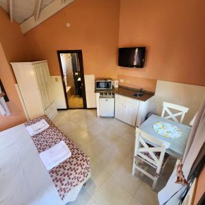 a small room with a kitchen and a table at Merlo Trail Lodge in Merlo