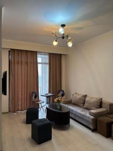 a living room with a couch and a table at Alvina House in Tsaghkadzor